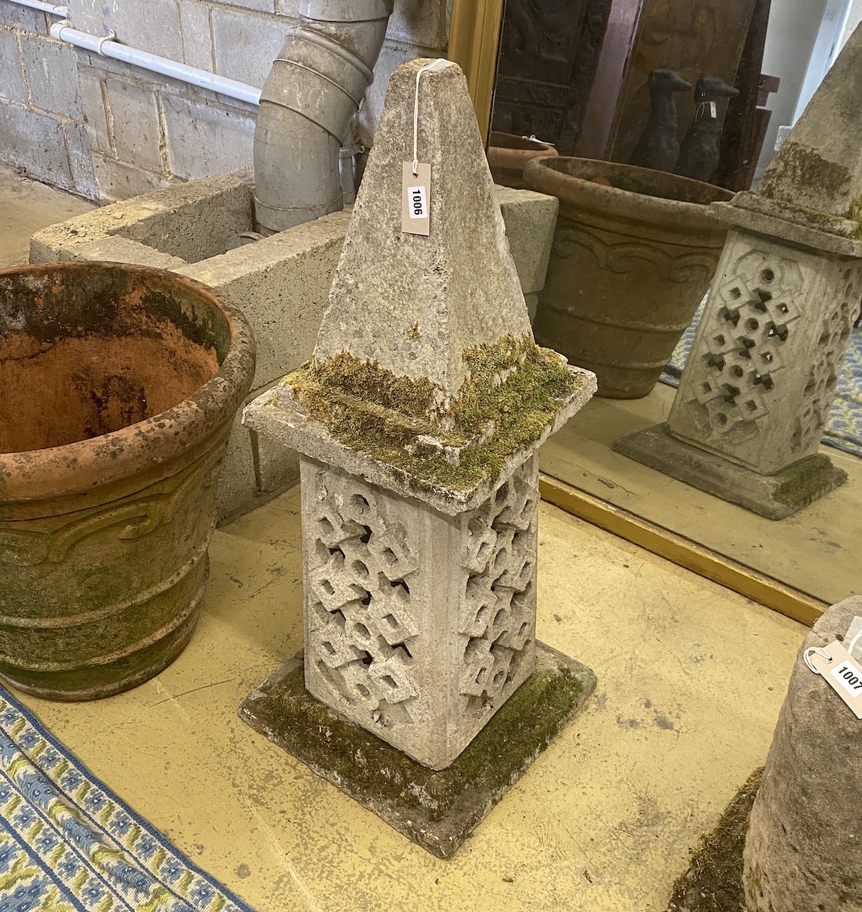 A reconstituted stone garden obelisk on square plinth, height 90cm